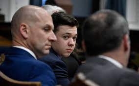 Kyle Rittenhouse, center, looks over to his attorneys as the jury is dismissed for the day during his trial at the Kenosha County Courthouse in Kenosha, Wis., on Thursday, Nov. 18, 2021. (Sean Krajacic/The Kenosha News via AP, Pool)