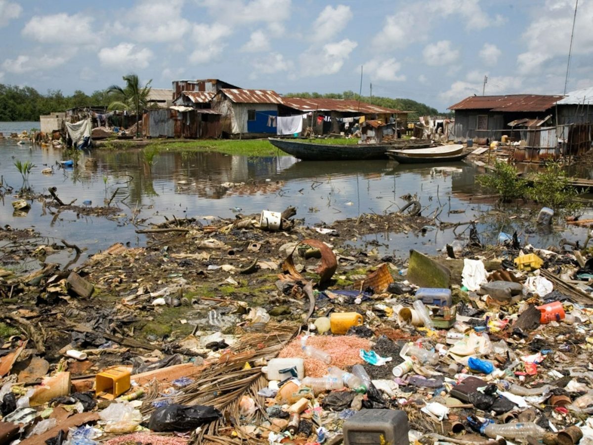 Plastic rubbish litters the waters of a fishing village in the Niger Delta of Nigeria. Plastic pollution is only one type of pollution that harms the marine environment. Photograph by Ed Kashi.