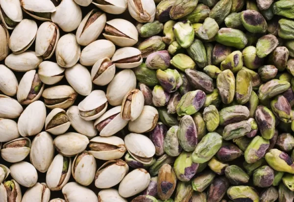Unshelled and shelled pistachio nuts. Photo Credit: James A Guilliam/Getty Images. 
