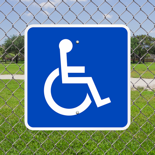 Wheelchair accessibility sign on a chain link fence. Photo credit: MyParkingSign.com.