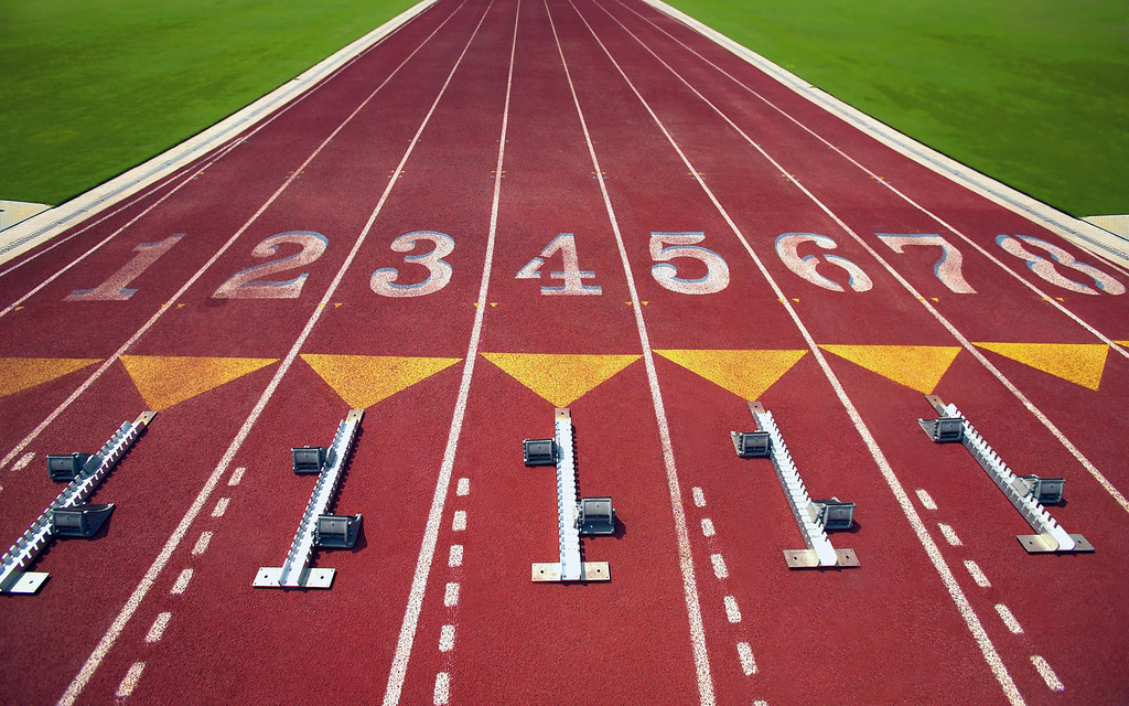 A track with numbered lanes and starting blocks. Photo credit: Jupiterimages on Flickr